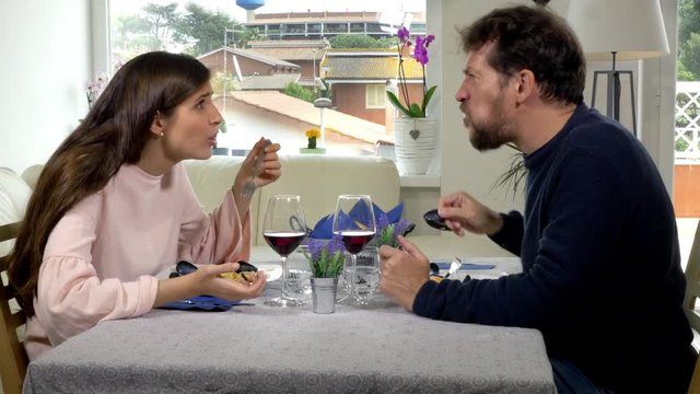 Man being rude at the table with girlfriend making burp