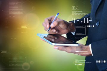 Business man writing on the digital tablet