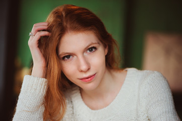 closeup indoor portrait of beautiful redhead woman 