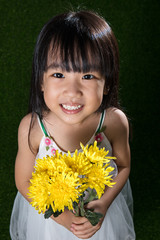Asian Chinese little girl holding flowers
