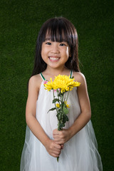 Asian Chinese little girl holding flowers