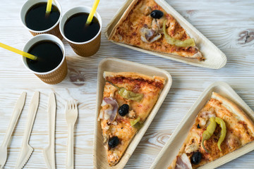 A slices of pizza is on a wooden plate.