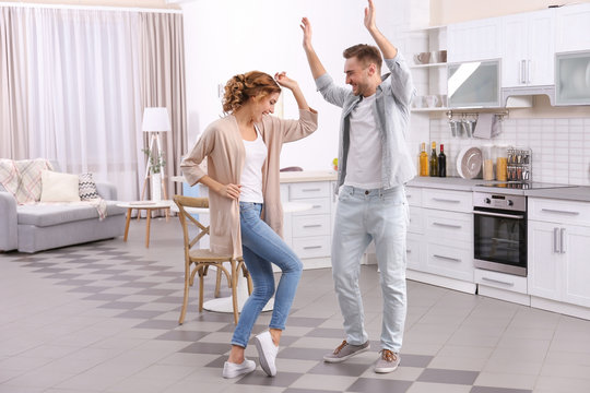 Cute young couple dancing at home