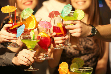 Friends with tasty cocktails at party, closeup