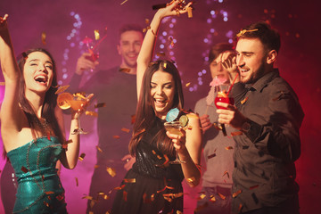 Friends having fun at party in night club