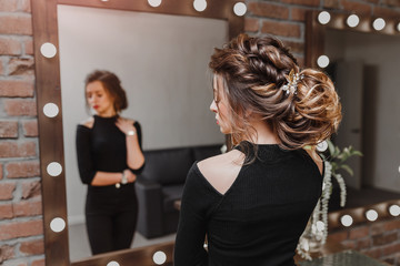 attractive young brunette woman with beautiful hairstyle with hair detail accessory, closeup rear view © EdNurg