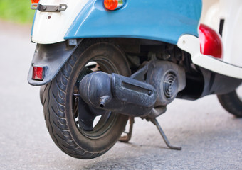 The exhaust of blue retro scooter