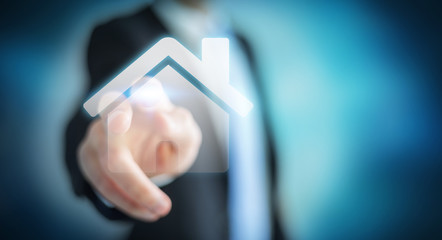 Businessman touching 3D rendering icon house with his finger