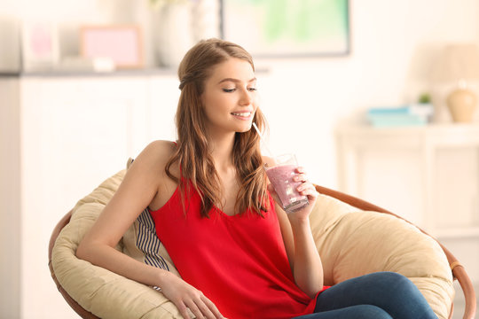 Weight loss concept. Beautiful young woman drinking healthy delicious smoothie at home