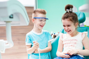 Little children play in the dentist in the dental office