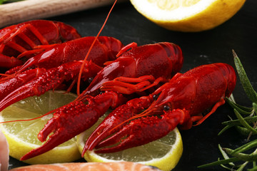 tasty boiled crawfish closeup on stone table, seafood dinner, nobody