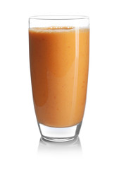 Glass of orange yogurt smoothie on white background