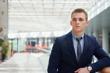 A portrait of young business man indoors