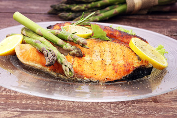 Grilled salmon and asparagus on plate