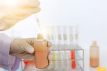 scientist hand holding laboratory test tube, science laboratory research and development concept