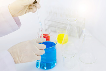 scientist hand holding laboratory test tube, science laboratory research and development concept