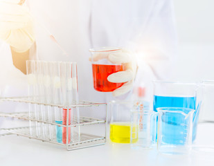 scientist hand holding laboratory test tube, science laboratory research and development concept