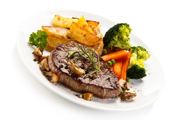 Grilled beefsteak with broccoli and carrot on white background