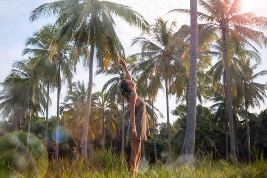 boho woman posing at palm trees background
