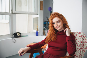 Fototapeta premium Portrait of a beautiful young redheaded woman