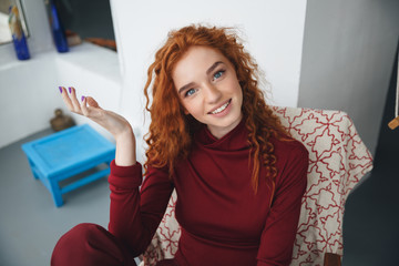 Portrait of a smiling young redheaded woman
