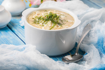 Tasty mushroom soup with noodles on a wooden table.