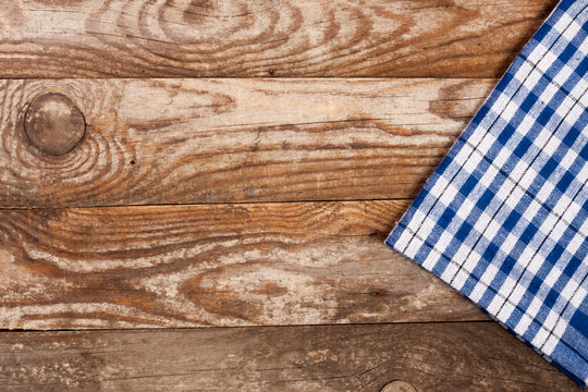 blue checkered tablecloth on the old wooden table with copy space for your text. Top view