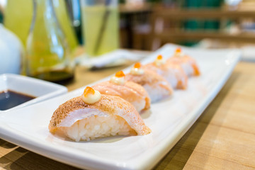 Row of grilled salmon sushi