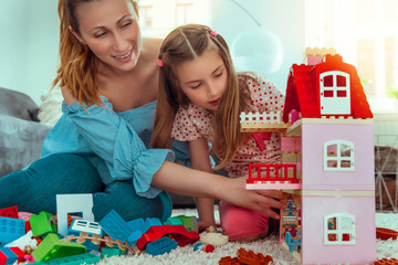 Fototapeta premium mother playing with kid child and toys