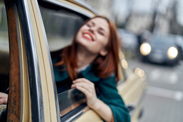Obraz na płótnie Canvas Woman peeking out of car window, woman sitting in car