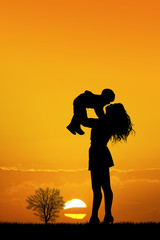 happy woman with son at sunset