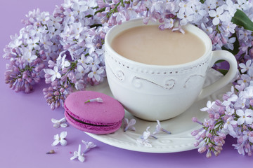 Romantic background with cup of tea, lilac flowers