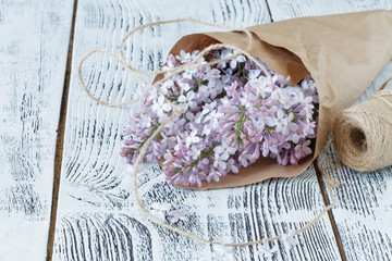 Lilac flowers on background of shabby wooden planks in rustic style