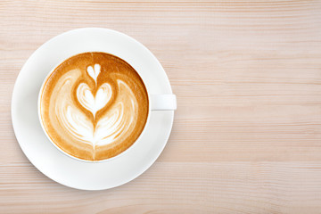 Top view latte art coffee on wood background