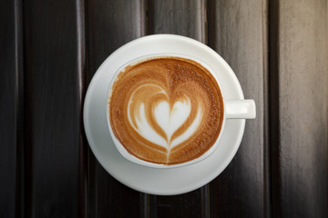 Coffee latte art in coffee shop in vintage color filter