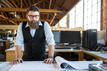 Stylish worker hipster with beard at the workplace in modern creative business for marketing...