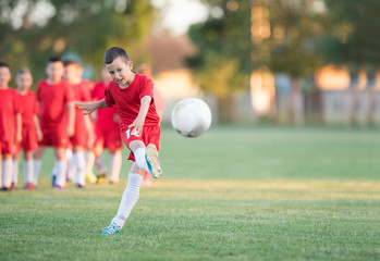 Kids soccer football - children players exercising before match on soccer field