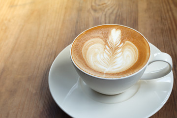 Coffee latte art in coffee shop in vintage color filter