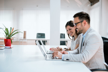 Cheerful office workers discussing their project