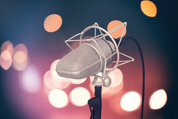 Professional microphone on bright colored background, mic