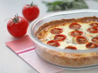 Close up of rustic custard pie with vegetables and cheese. Traditional quiche pastry.