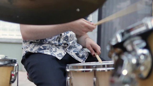 Drummer musician playing jazz in a outdoors performance.
