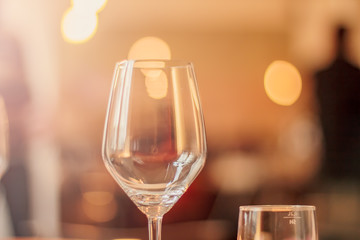Wine glass in a restaurant closeup, warm and elegant