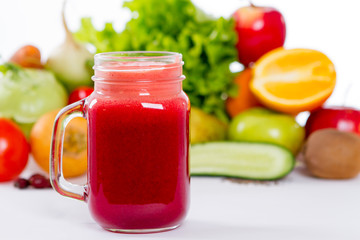 vegetable smoothie in a glass on a background of vegetables