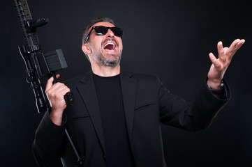 Gangster boss with big rifle having fun