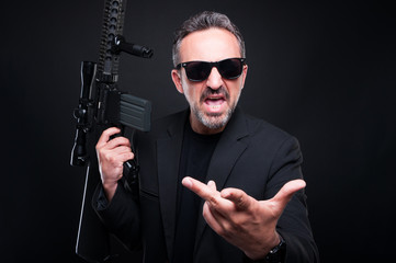 Aggressive gangster with rifle fighting