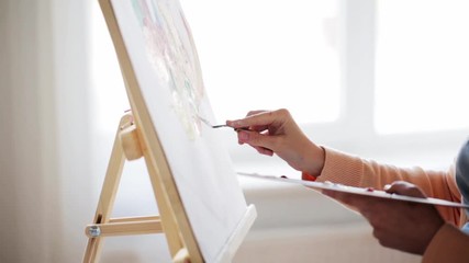 artist with palette knife painting at art studio