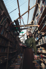 Fototapeta na wymiar Girl standing in library with books