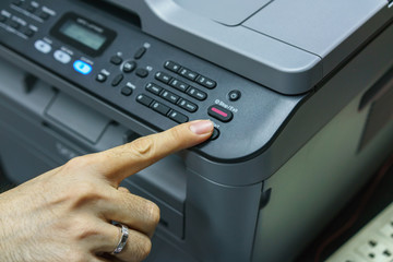 Finger pressing start button of fax machine , office equipment