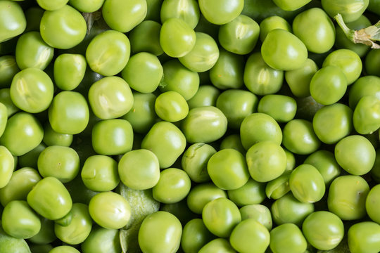 Flat lay pile of fresh green peas closeup macro